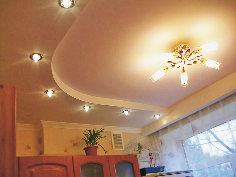 Chandelier on the white ceiling of the kitchen