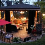 A cozy gazebo with a barbecue area