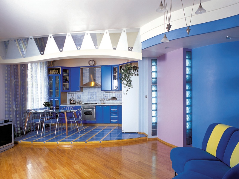 Blue color in the interior of the kitchen-living room with a podium