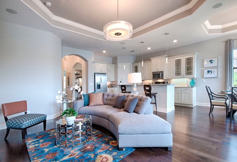 Arc-shaped sofa in the kitchen-living room with plasterboard ceiling