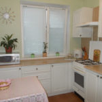 Kitchen window decor with roller blinds