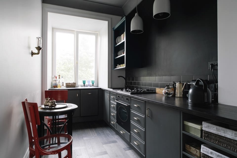 Black wallpaper on the wall of the kitchen in the loft style