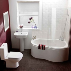 White plumbing in a bathroom with a dark floor