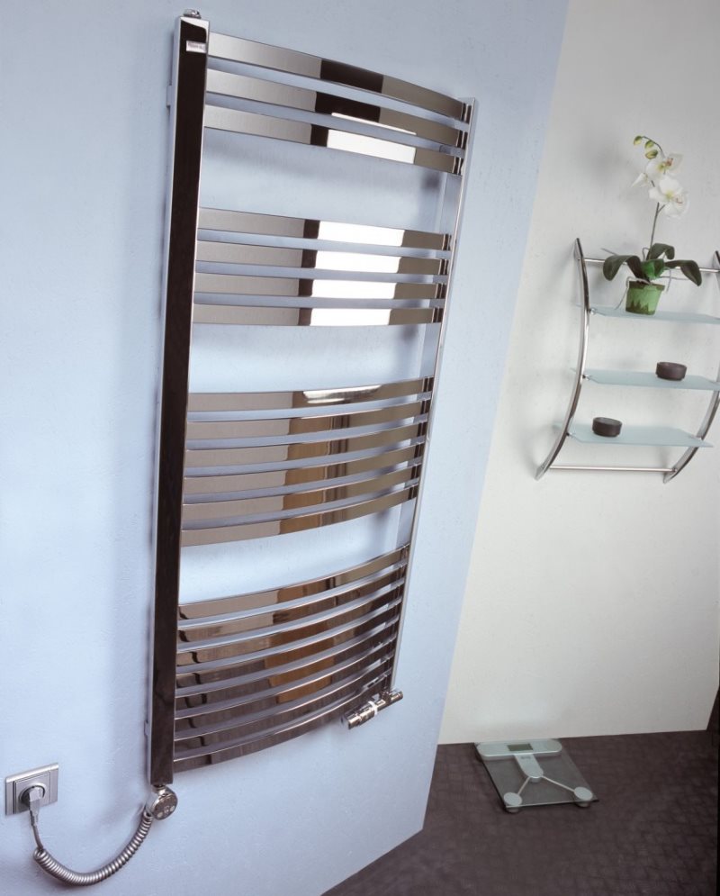 Electric heated towel rail on the bathroom wall