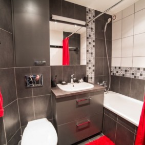 Red curtain in the bathroom with dark walls
