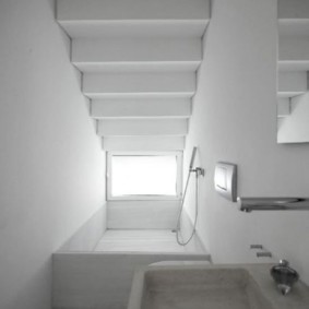 Narrow bathroom under the stairs in a private house