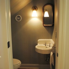 Toilet lighting under a wooden staircase
