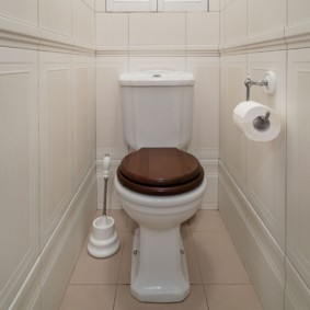 Wooden lid on a white toilet