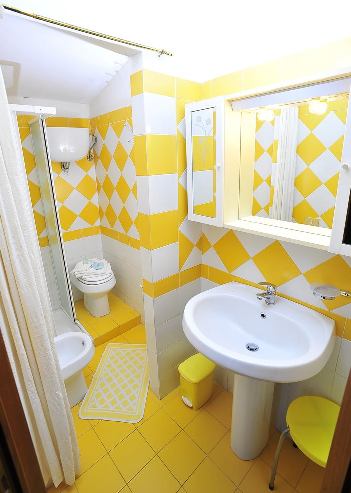 Lemon-white interior of a compact bathroom