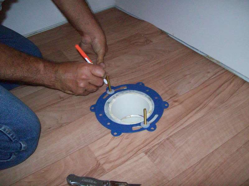 Installing a toilet on a wooden floor of a toilet