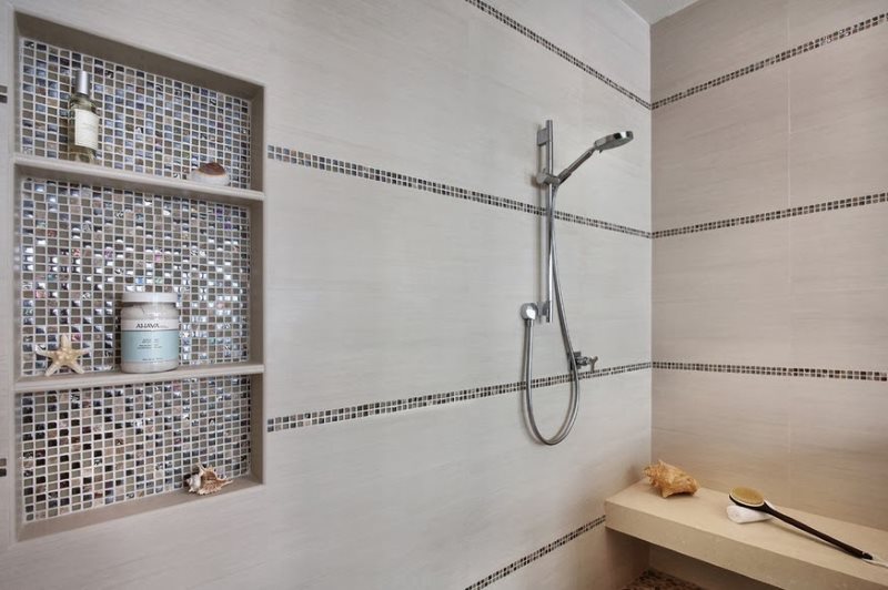Niche in the wall of the bathroom with mosaic trim