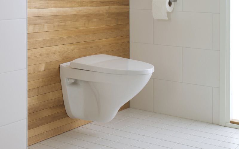 White wall hung toilet on a wooden wall
