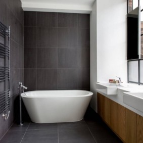 White bath in a room with dark walls