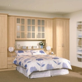 wardrobes over the bed in the bedroom design photo