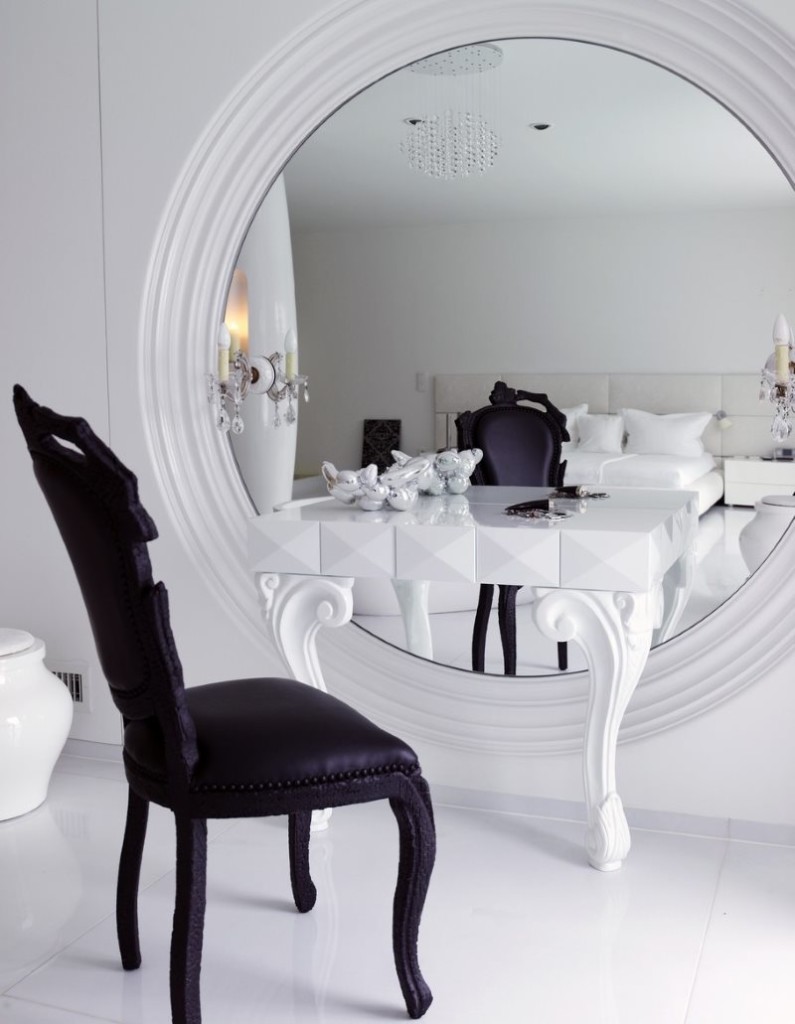Dressing table in front of a large wall mirror