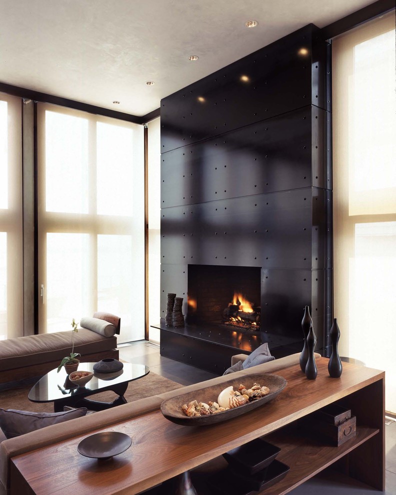 Black fireplace in the living room with large windows