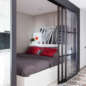 Bed behind a sliding glass partition