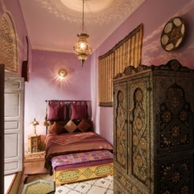 Narrow bedroom with wooden wardrobe