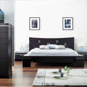 Black bed in a white room