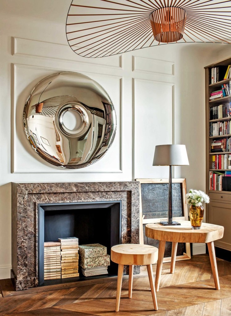 Piles of books inside a raised fireplace in a living room