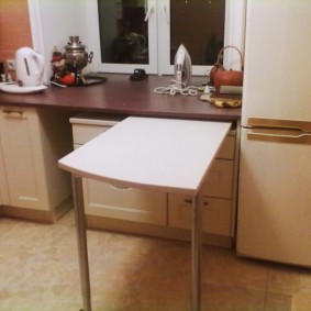 A small table in the kitchen of a city apartment