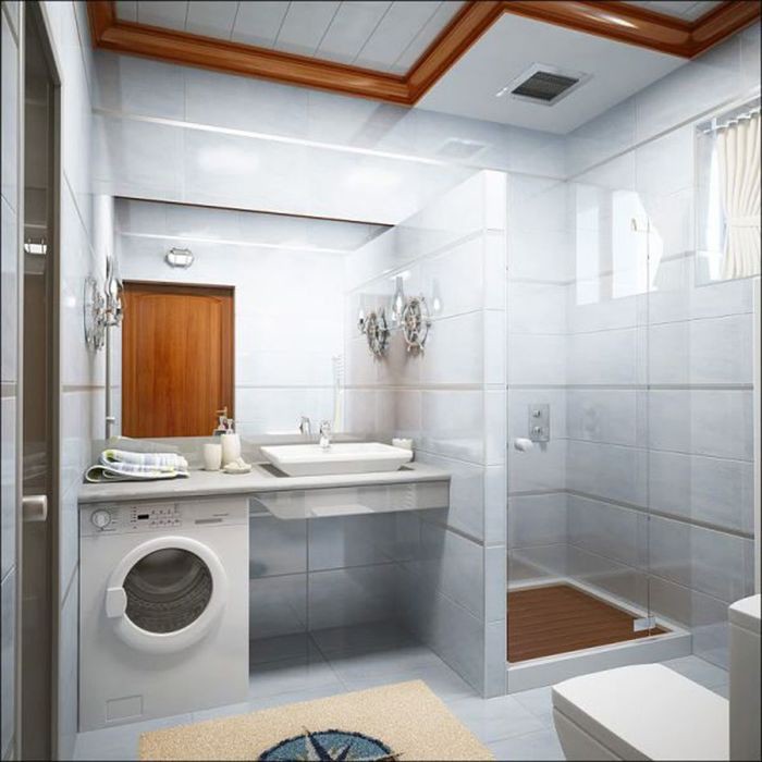 Shower cubicle in the bathroom with a washing machine