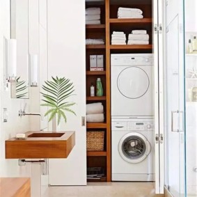 Bílé ručníky ve skříních s dřevěnými policemi