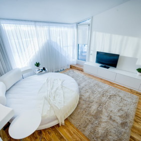studio apartment with a bed and a sofa design photo