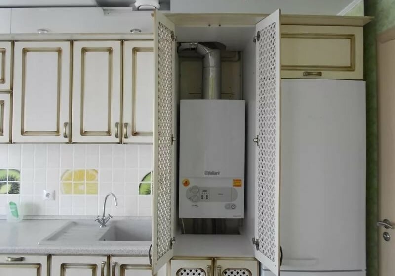 Wall-mounted gas boiler in the cabinet with lattice doors