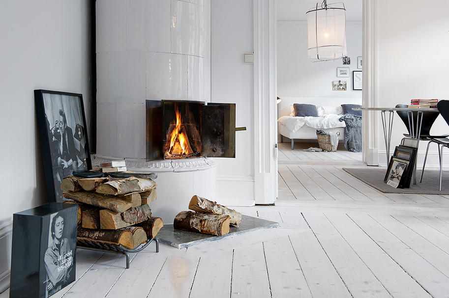 Wood burning fireplace in a white living room