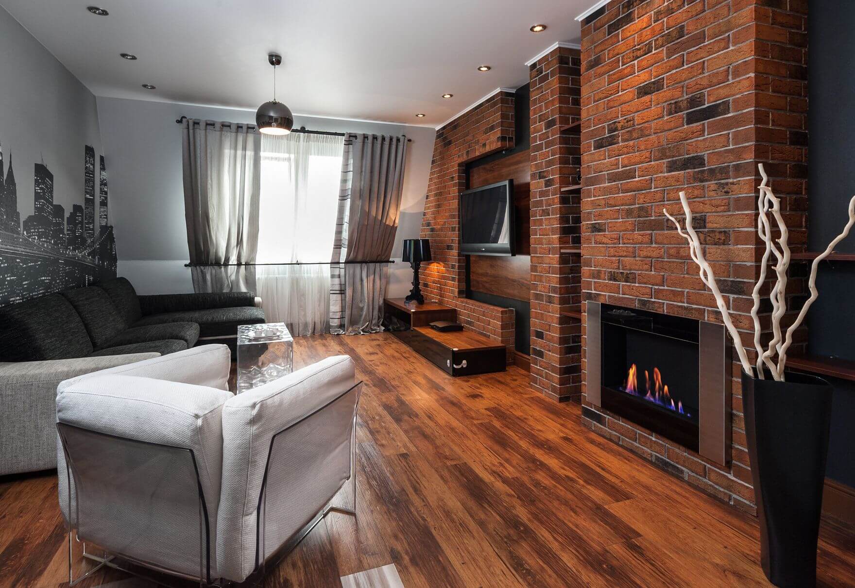 brick wall with fireplace and TV in the living room