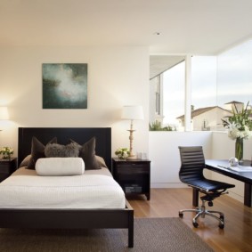 Narrow bed in the bedroom of the apartment