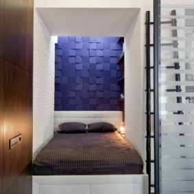 Bed in a niche in a studio apartment