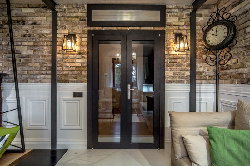 Double-wing swing door in a house with brick walls