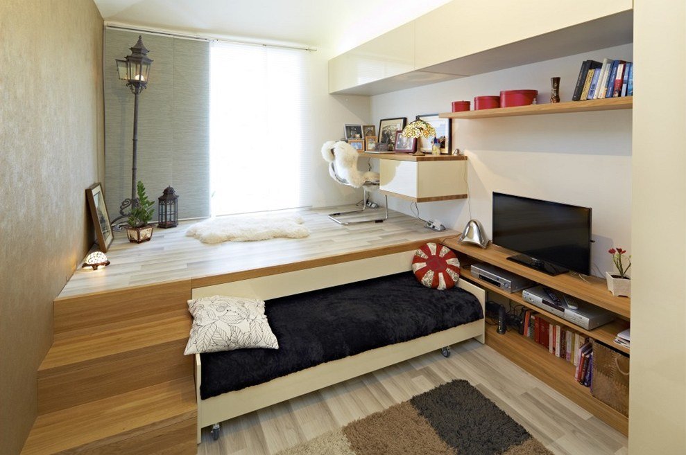 Bed in the wooden podium of a studio apartment