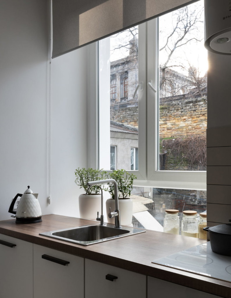 Sink in front of window with roller blind