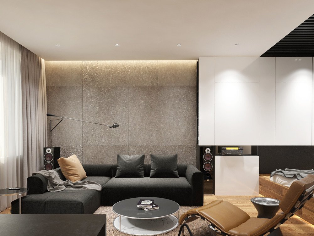 Pelēks dīvāns moderna stila vecpuiša dzīvoklī