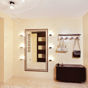 Dark brown pedestal in a bright hallway