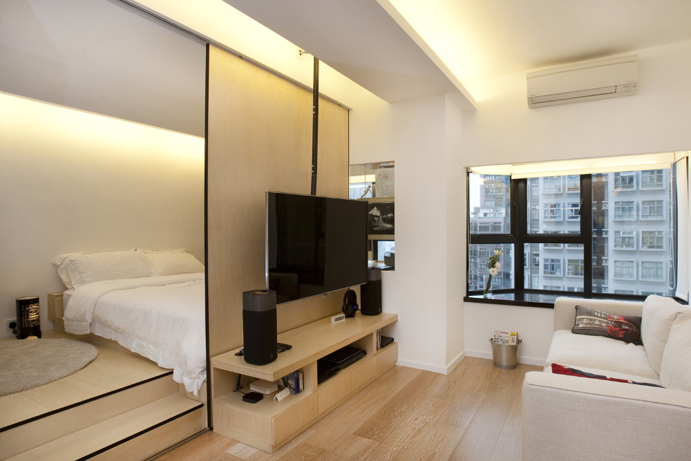 Bedroom behind a sliding partition in a studio apartment