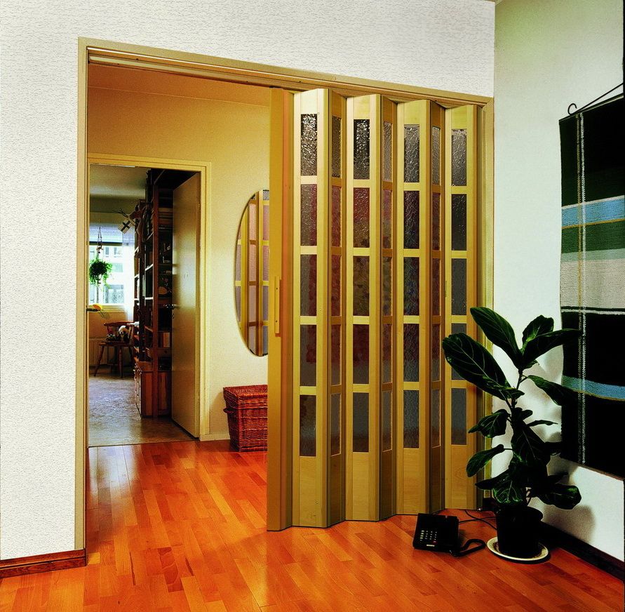 Accordion door with glass inserts