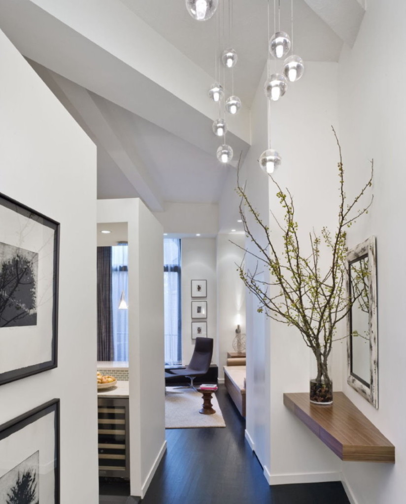 Pendant lights on the white ceiling of the hallway