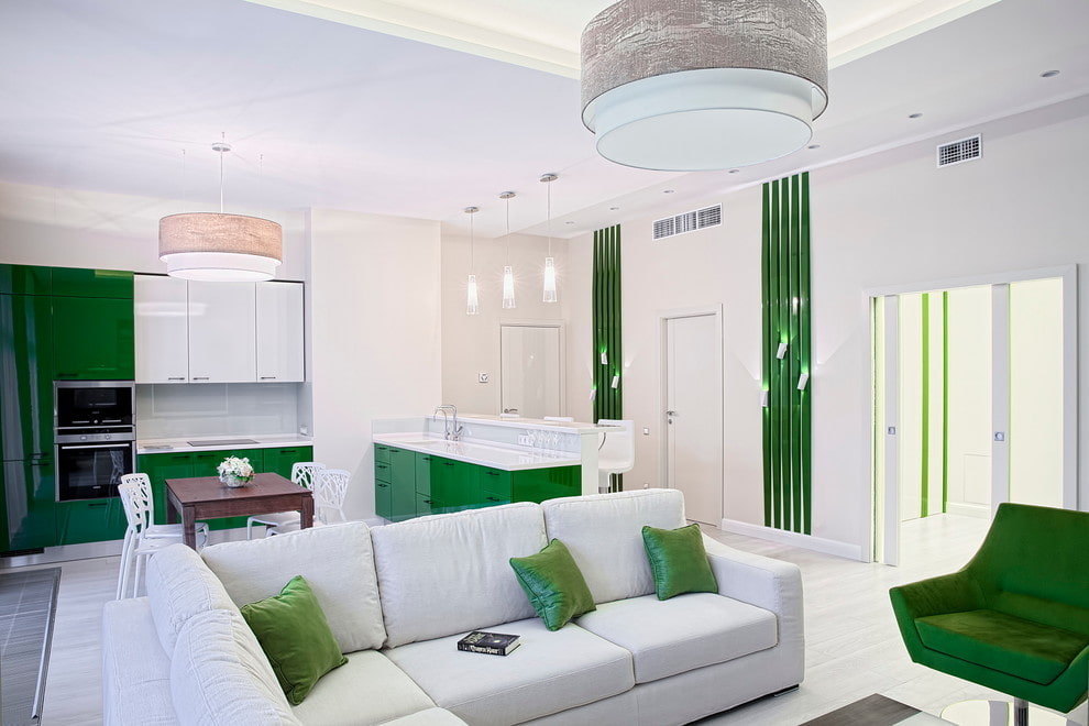 Green accents in the white kitchen-living room