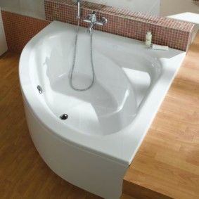 Bacia de banho branca em um piso de madeira