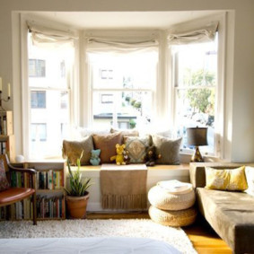 Pillows and toys in the bay window of a living room apartment