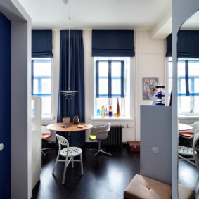 Dark blue curtains on the windows of the living room kitchen
