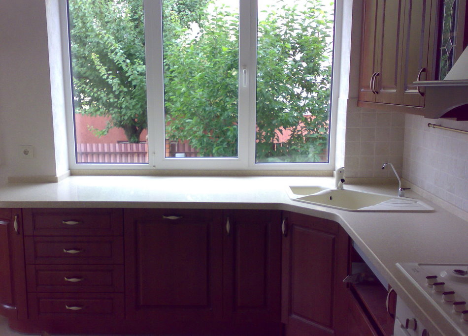 Un lavandino trapezoidale di fronte a una finestra della cucina in una casa privata