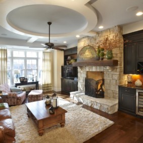 Design of a kitchen-living room with a fireplace in the interior