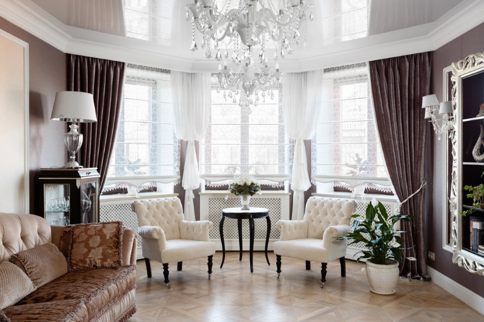 Crystal chandelier on living room ceiling with bay window