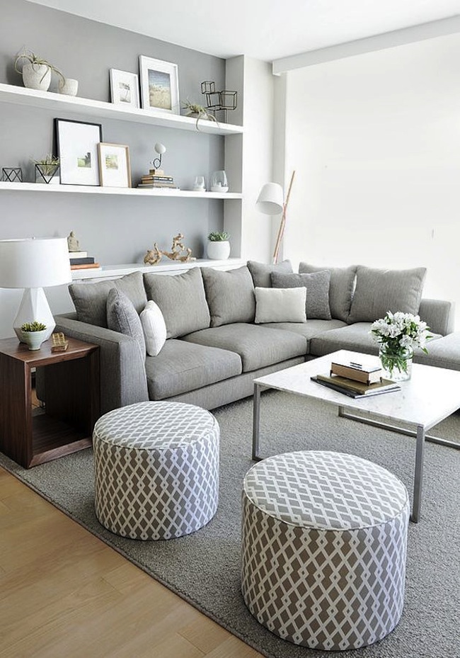 The interior of a small living room in a gray-white palette