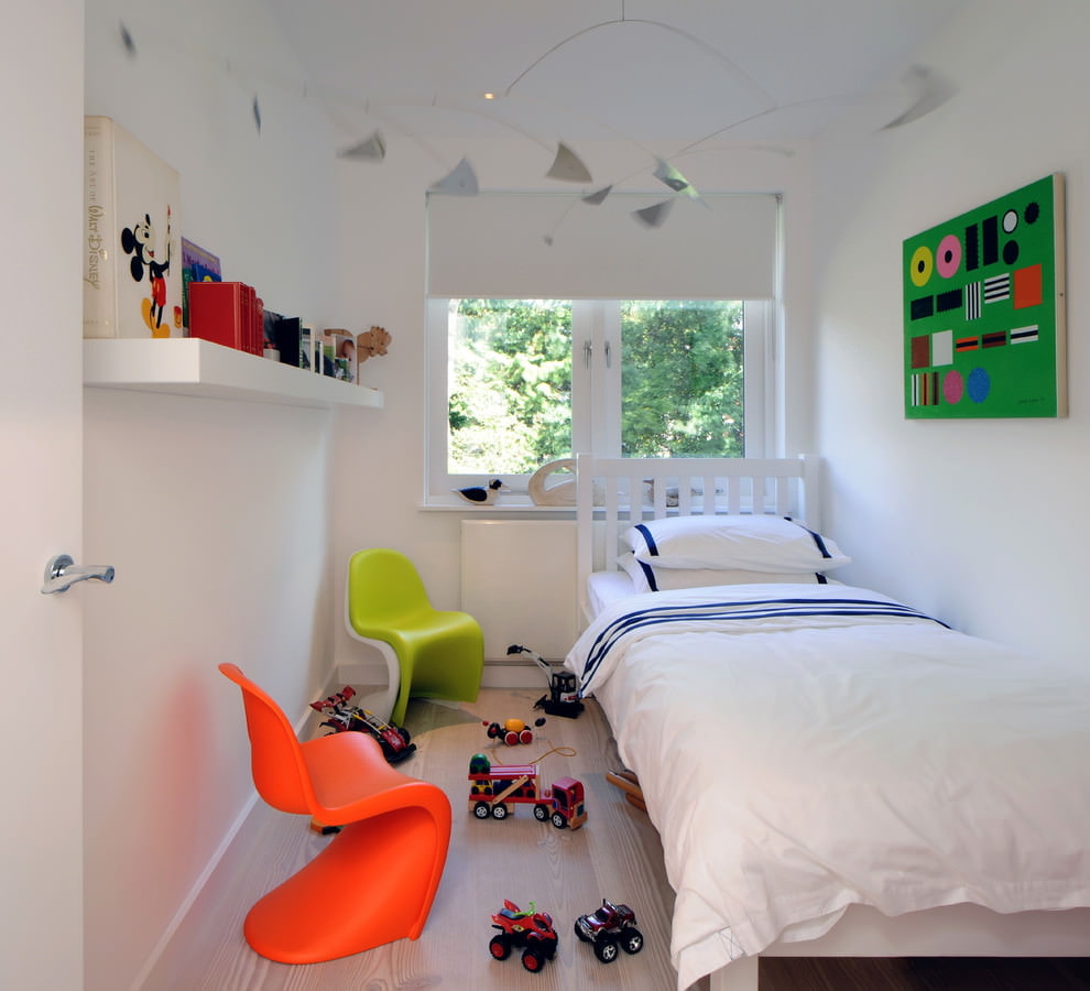 Colored chairs in a room with a white bed